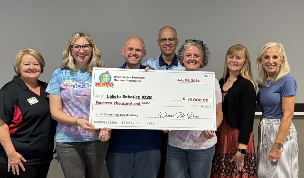 UCBMA presenting the 2025 Food Truck Rally check to Lakota Robotics Team 1038
