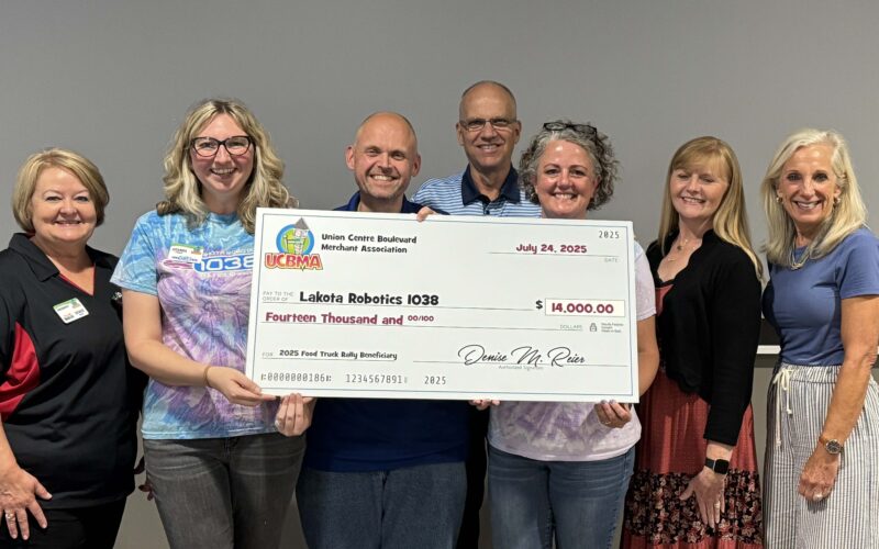 UCBMA presenting the 2025 Food Truck Rally check to Lakota Robotics